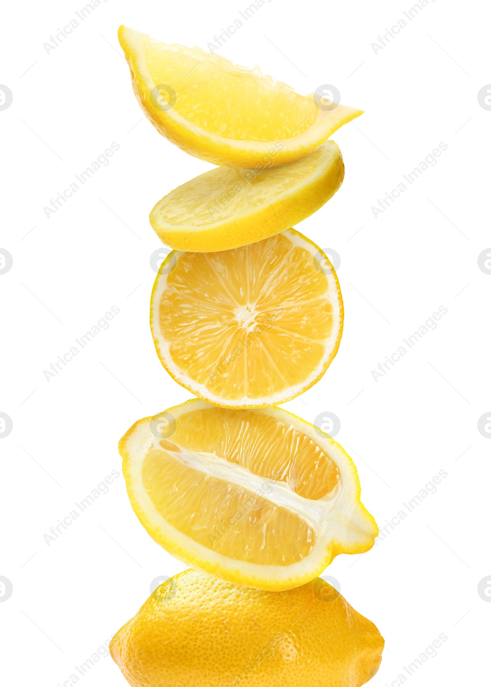 Image of Stacked cut and whole lemons on white background