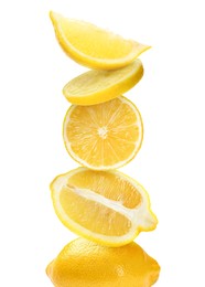 Stacked cut and whole lemons on white background