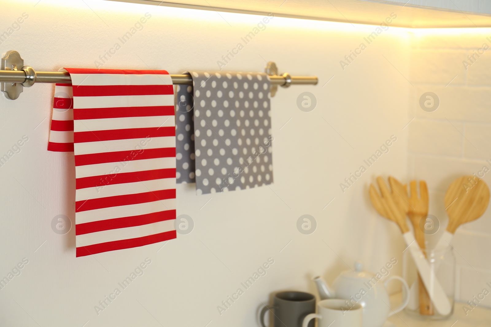 Photo of Clean kitchen towels on hanger in modern interior