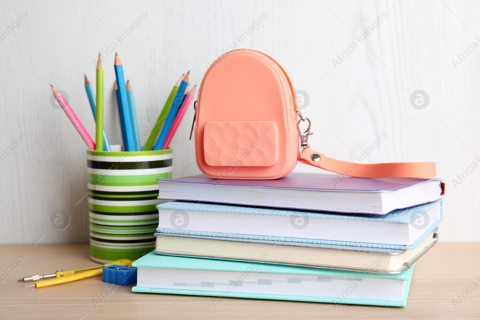 Photo of Different stationery on wooden table. Back to school