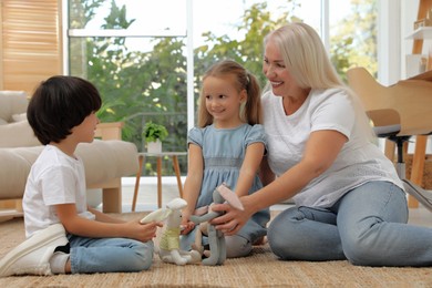 Grandmother playing with her grandchildren at home