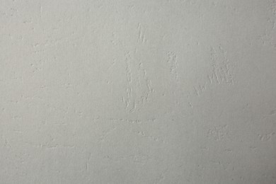 Photo of Texture of light grey paper sheet as background, closeup