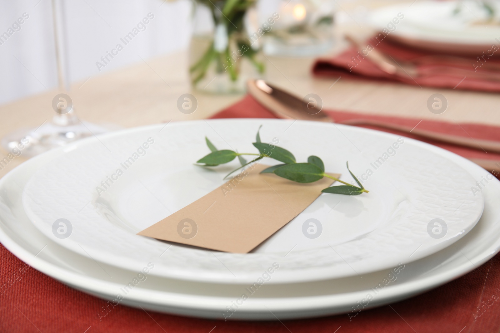 Photo of Elegant festive table setting with blank card in restaurant