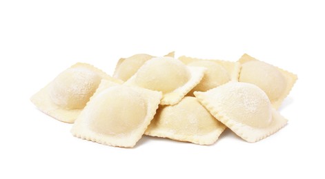 Uncooked ravioli with filling on white background