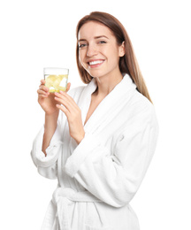 Young woman with glass of lemon water on white background