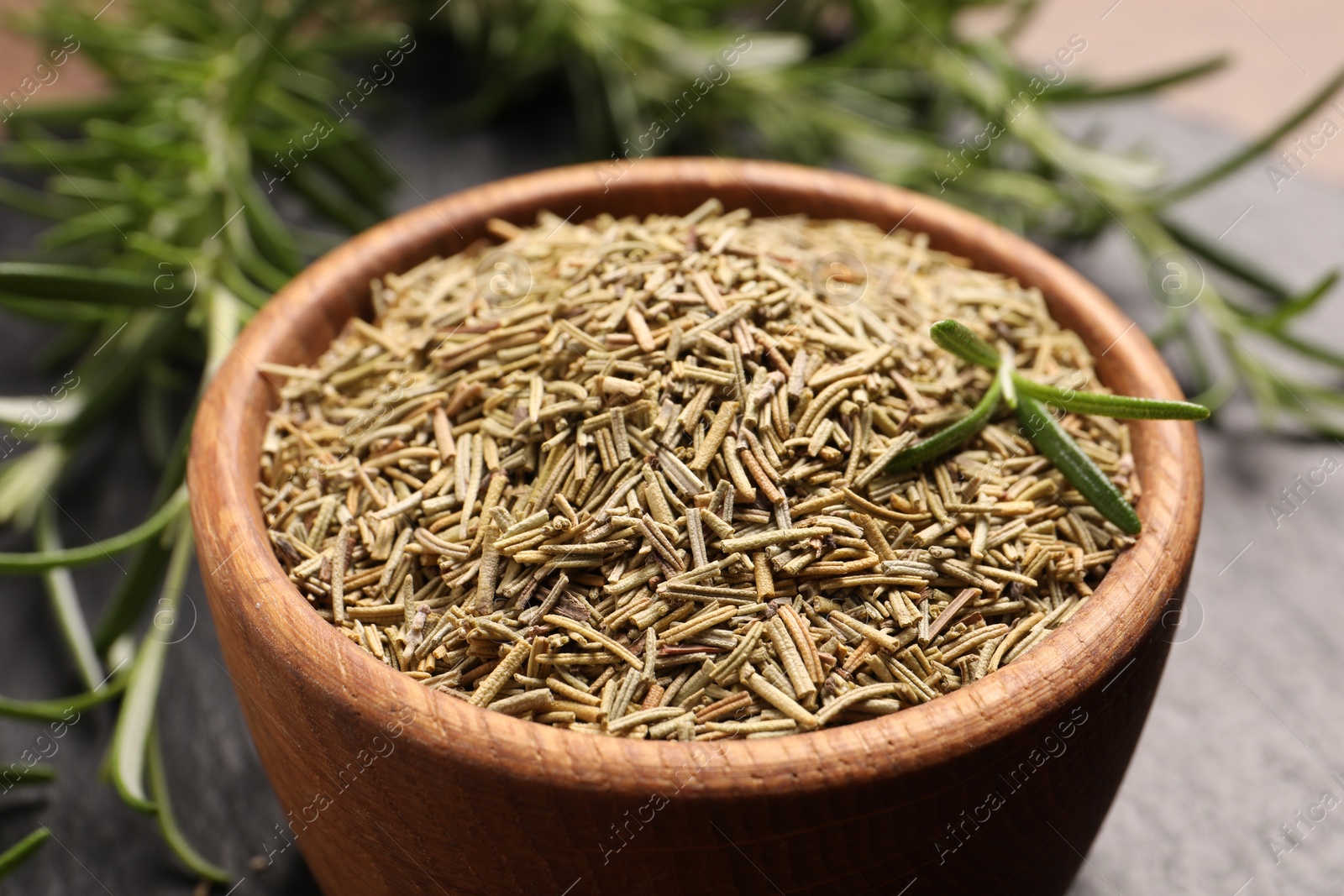 Photo of Closeup view of bowl with dry rosemary