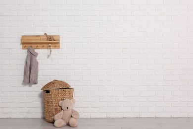 Photo of Beautiful children's room with white brick wall and toys, space for text. Interior design