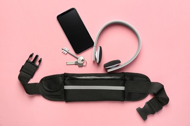 Photo of Flat lay composition with stylish black waist bag on pink background