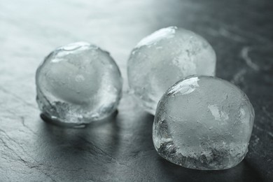 Frozen ice balls on black table, closeup