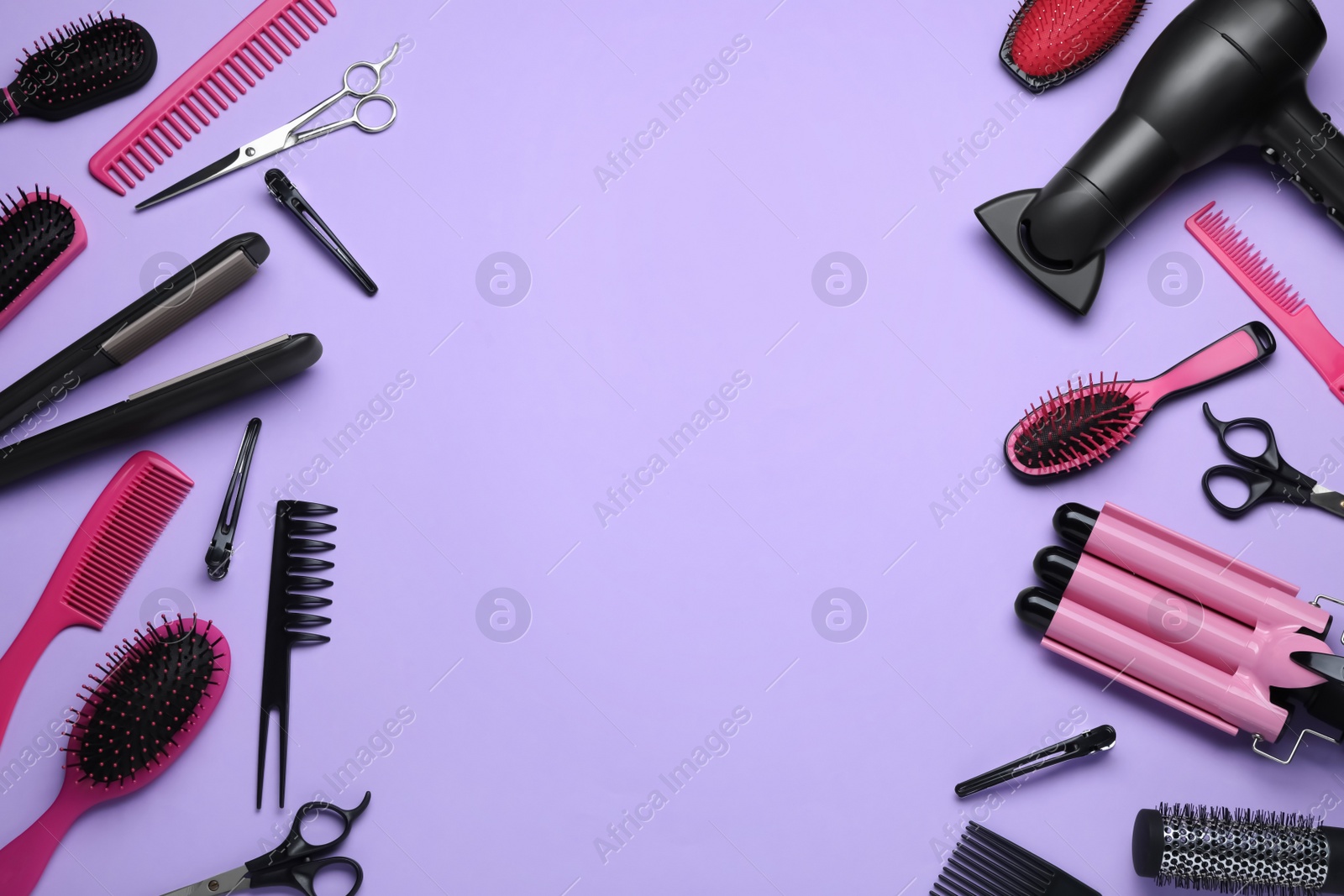 Photo of Flat lay composition of professional hairdresser tools on lilac background, space for text