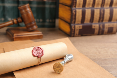 Photo of Notary's public pen and sealed document on wooden table