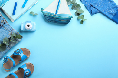 Photo of Flat lay composition with little photographer's toy camera on light blue background. Space for text