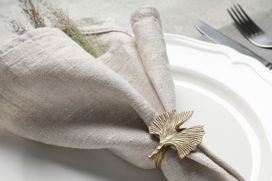 Photo of Fabric napkin, decorative ring and lavender on plate, closeup