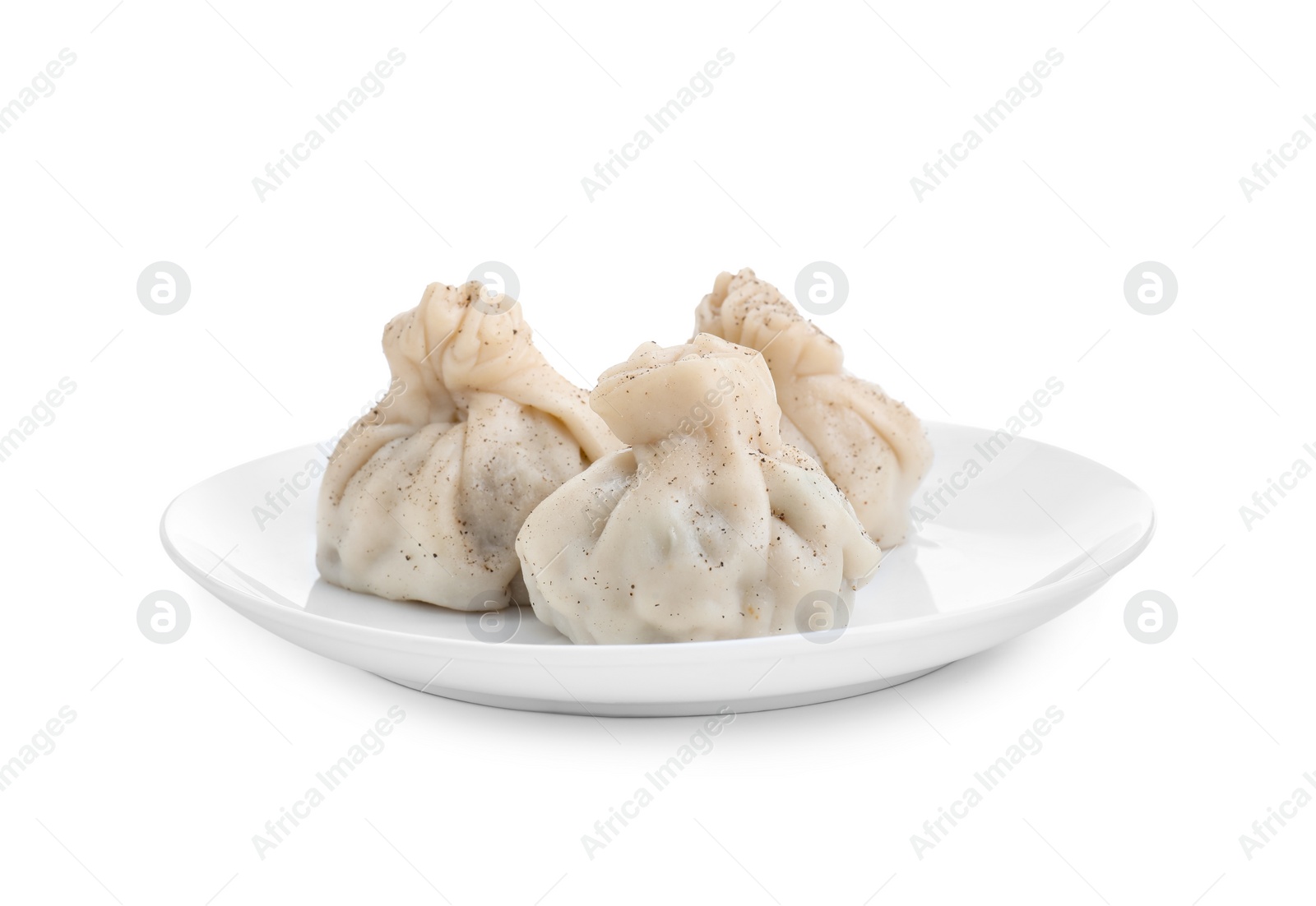 Photo of Plate with three tasty khinkali (dumplings) and spices isolated on white. Georgian cuisine