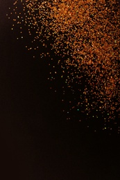 Gold glitter on black background, top view with space for text