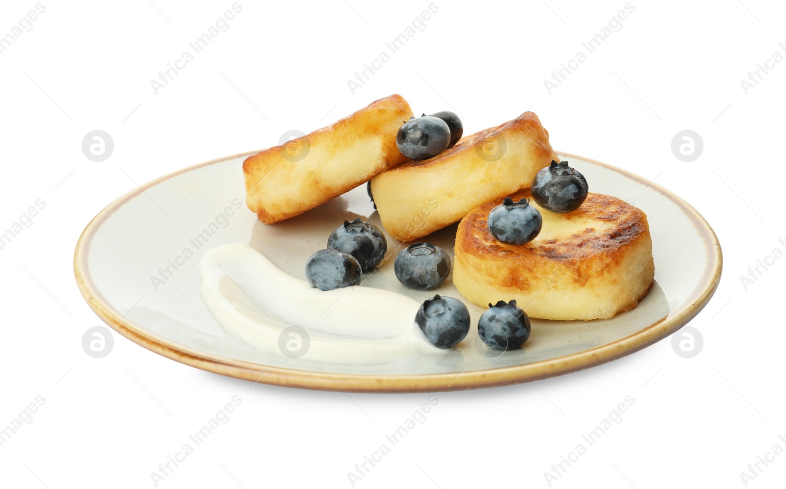 Photo of Plate with delicious cottage cheese pancakes, fresh blueberries and sour cream on white background