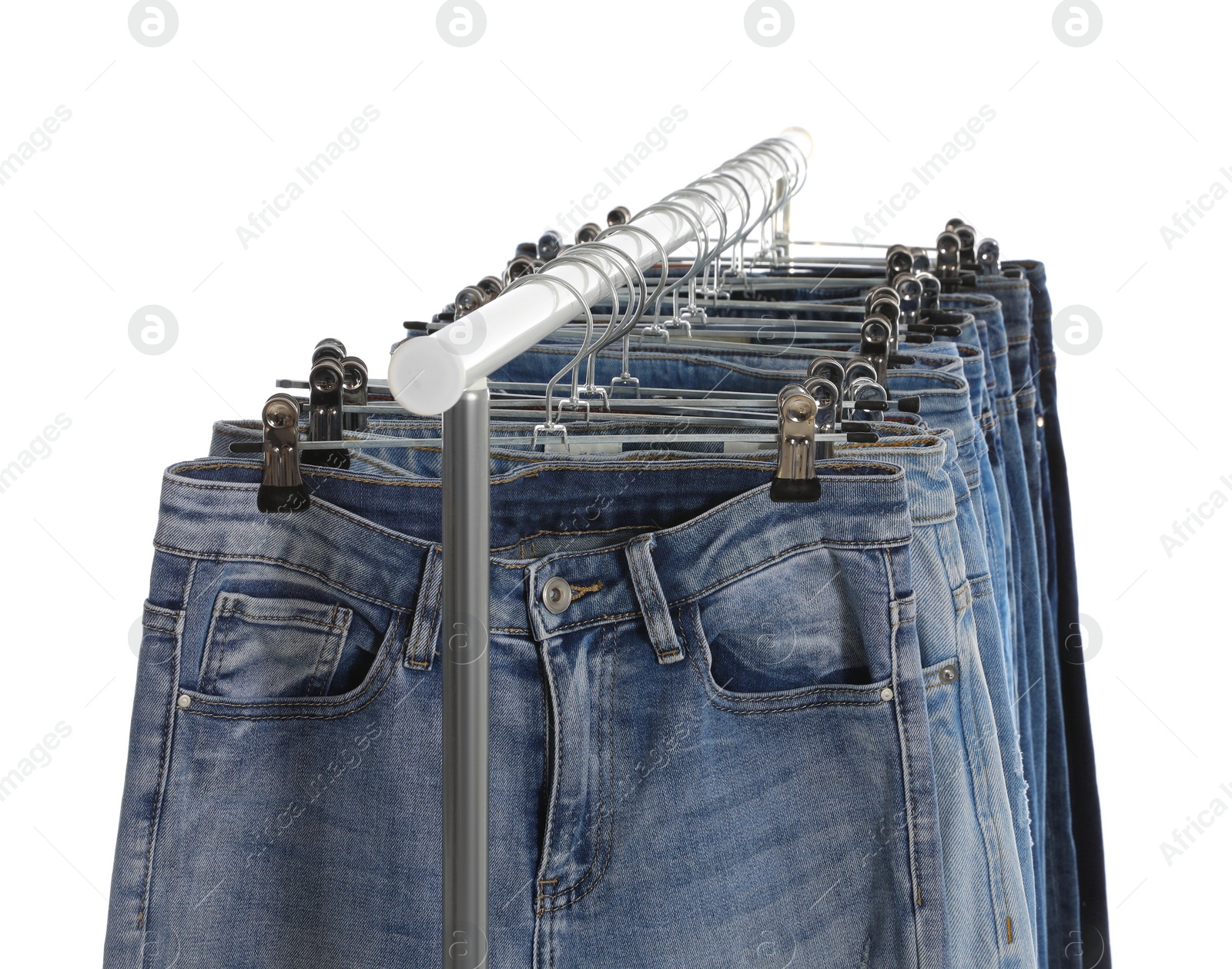 Photo of Rack with different jeans isolated on white