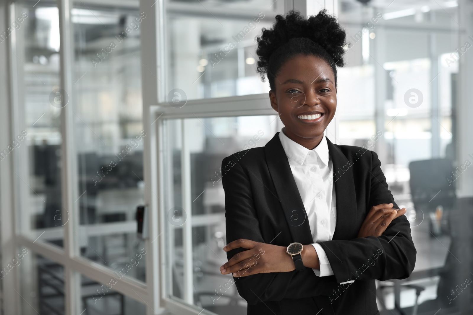 Photo of Happy woman with crossed arms in office, space for text. Lawyer, businesswoman, accountant or manager