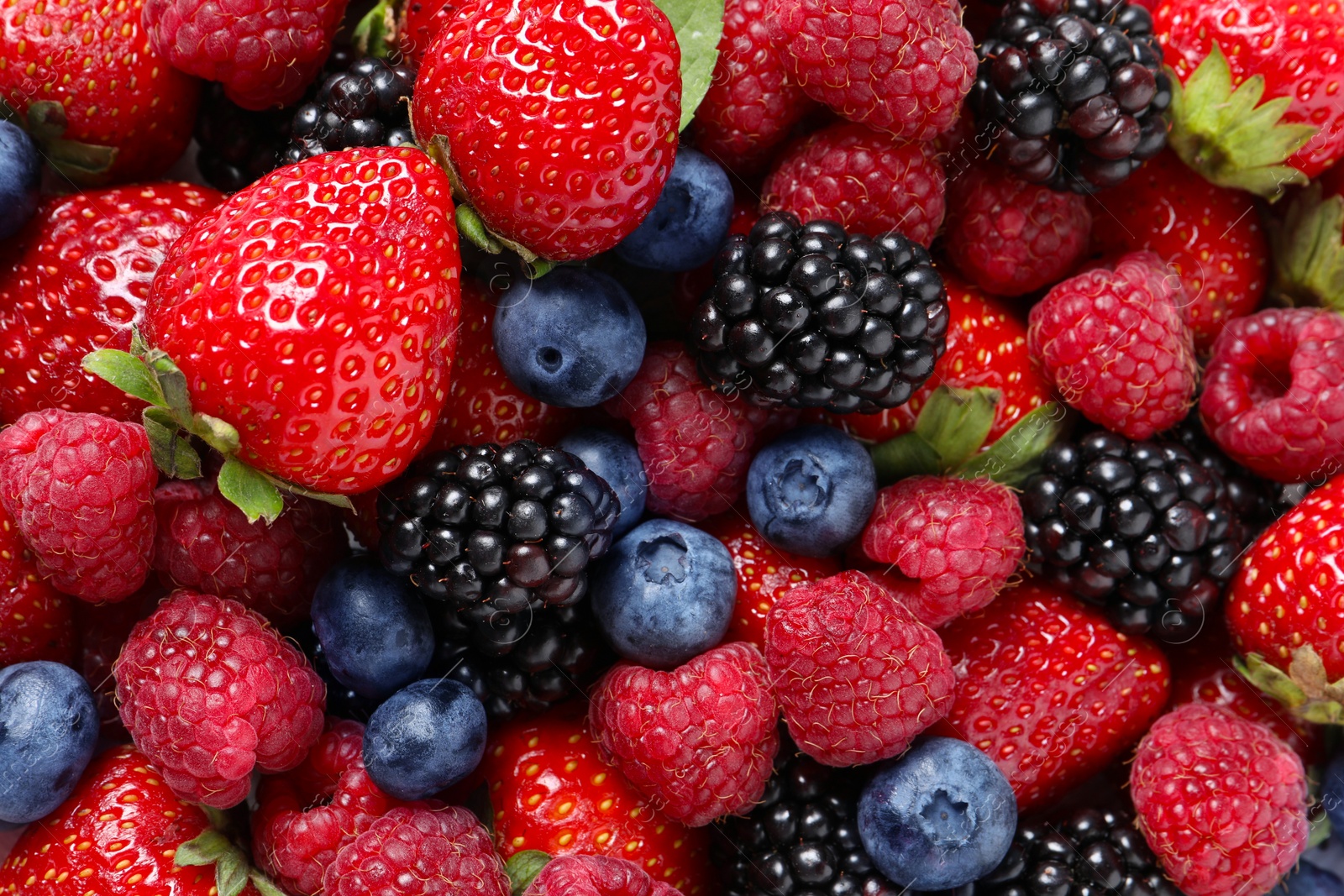 Photo of Different fresh ripe berries as background, top view