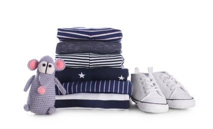 Photo of Stack of clean baby's clothes, toy and small shoes on white background