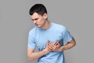 Photo of Man suffering from heart hurt on grey background