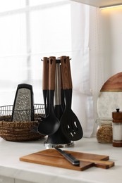 Set of different utensils on countertop in kitchen