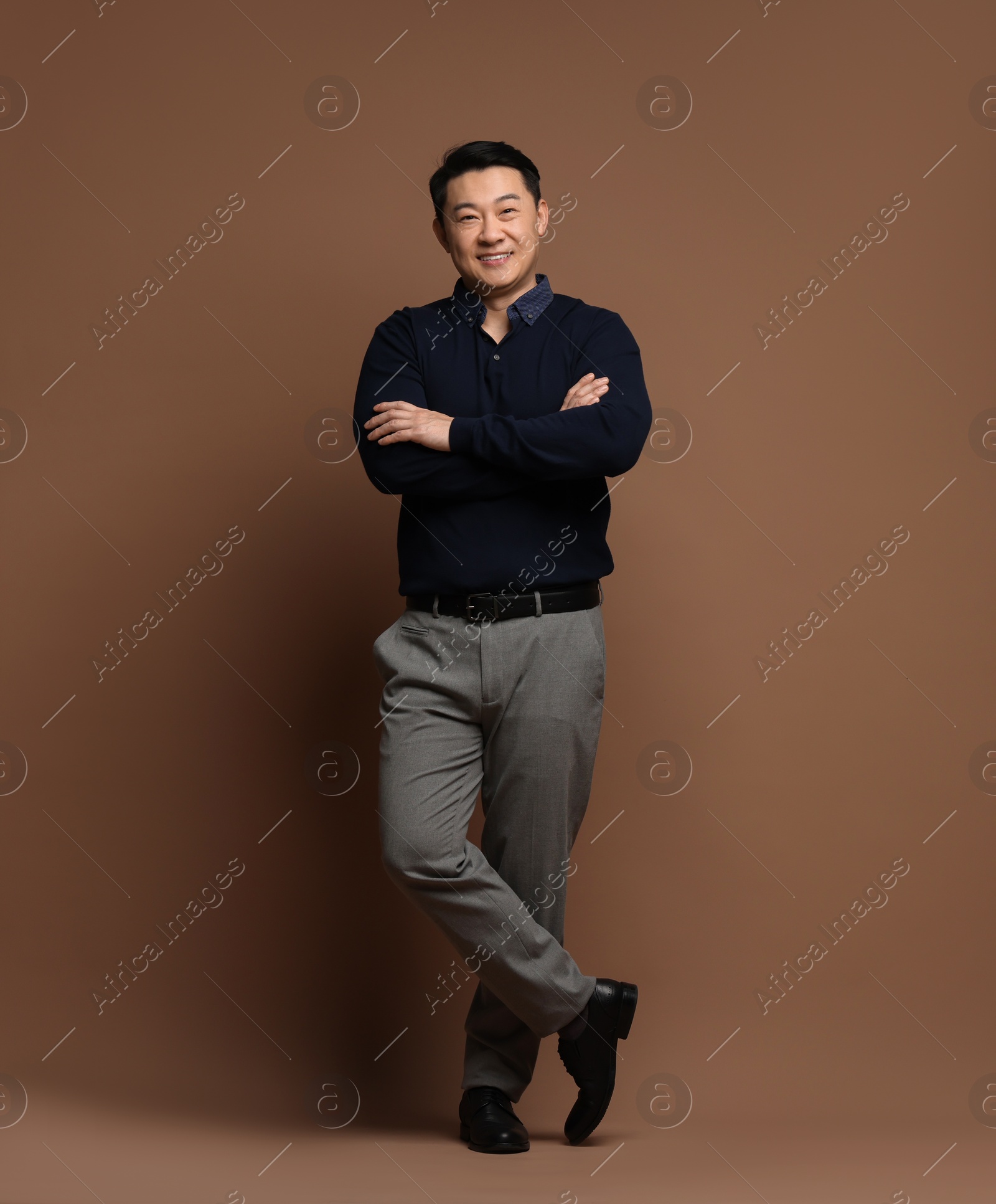 Photo of Full length portrait of happy man on brown background