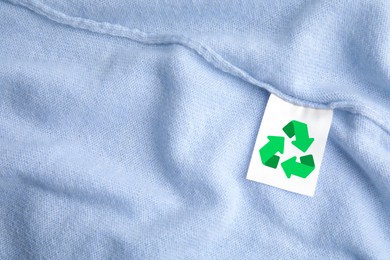Image of Clothing label with recycling label on cashmere sweater, closeup
