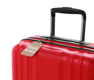 Photo of Red suitcase with TRAVEL INSURANCE label on white background