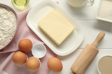 Photo of Flat lay composition with fresh butter and other products on white wooden table