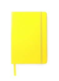 Photo of Closed yellow office notebook isolated on white, top view