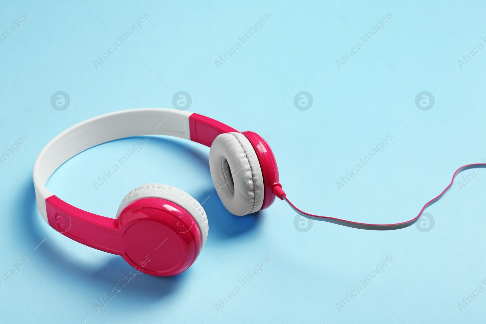 Photo of Stylish headphones on color background. Space for text