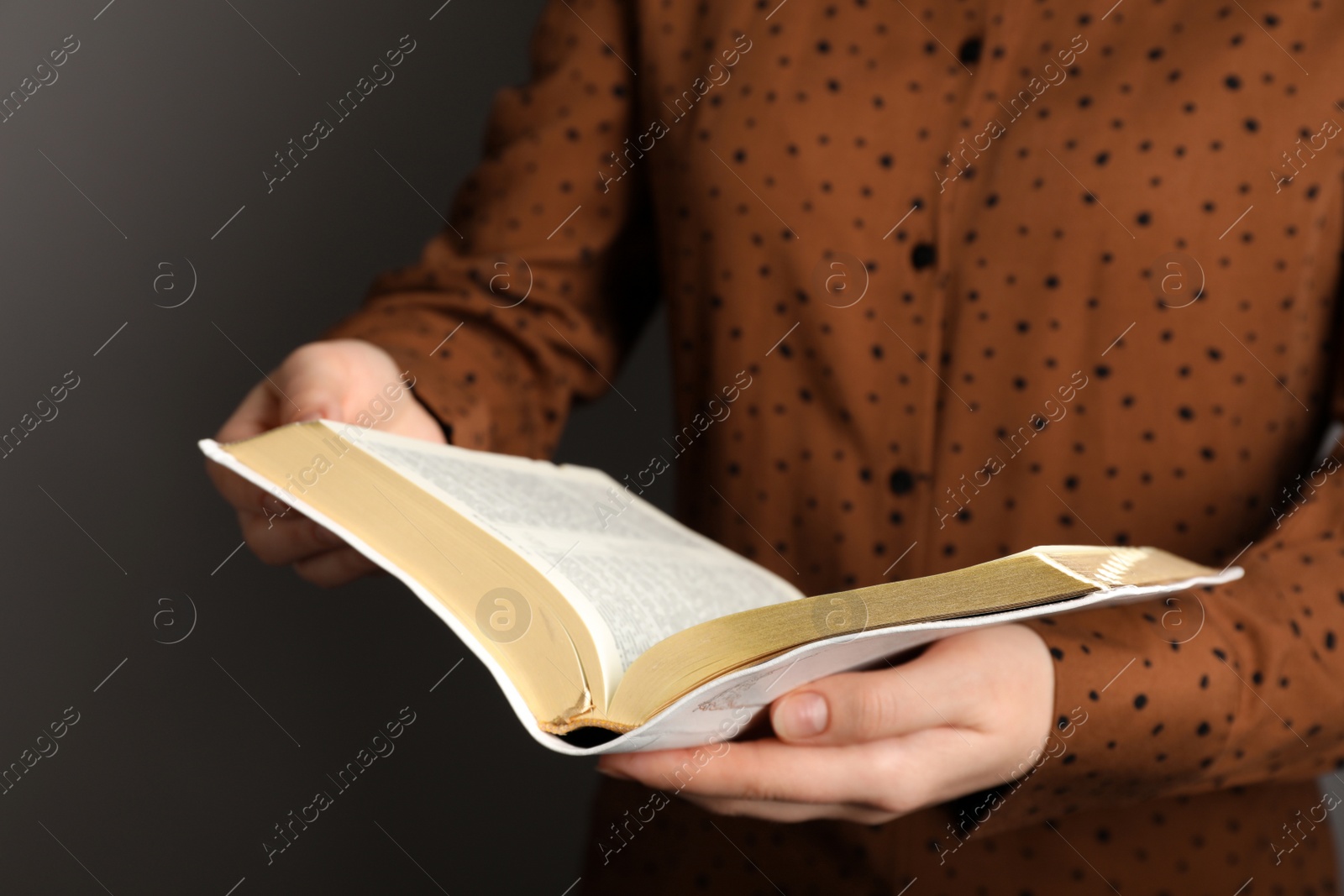 Photo of Humble woman reading Bible, closeup. Religious literature