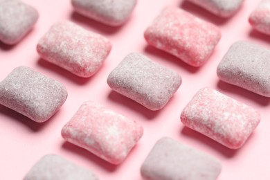 Photo of Tasty colorful bubble gums on pink background, closeup