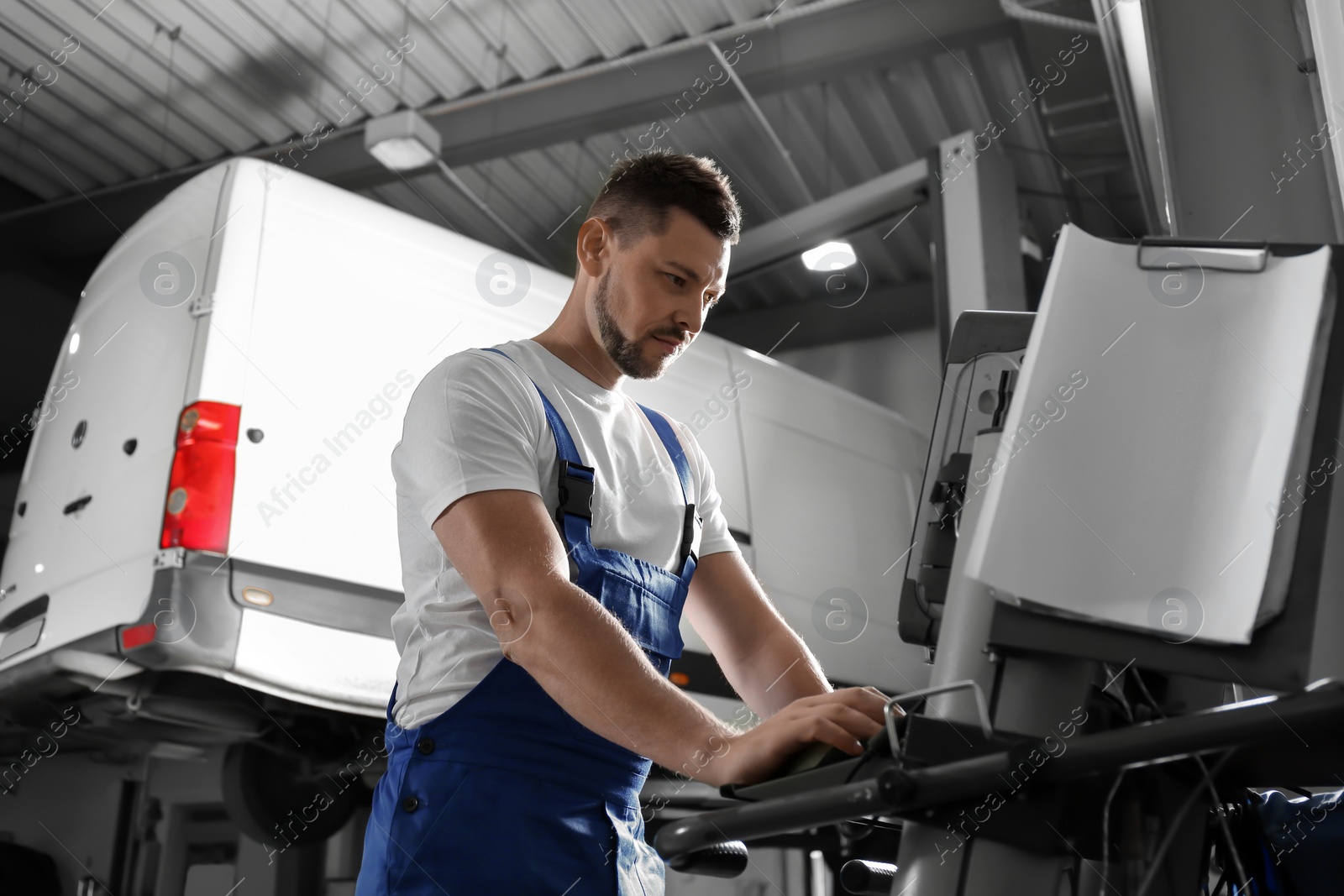 Photo of Mechanic doing car diagnostic at automobile repair shop