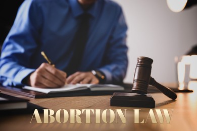 Image of Abortion law. Male lawyer at table in office, closeup