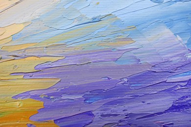 Photo of Beautiful strokes of colorful oil paints as background, closeup