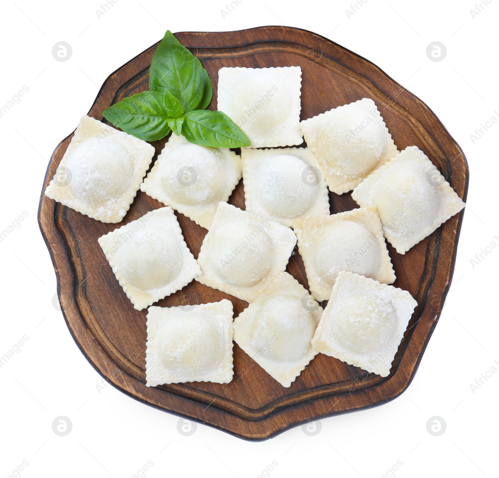 Photo of Uncooked ravioli and basil on white background, top view