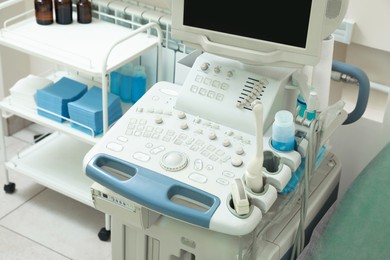 Photo of Ultrasound machine and medical trolley in hospital, closeup