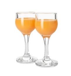 Photo of Tasty tangerine liqueur in glasses isolated on white