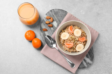 Photo of Tasty healthy breakfast served on light grey table, flat lay