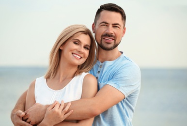 Happy romantic couple spending time together on beach