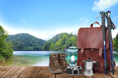 Camping equipment for tourist on wooden surface and beautiful view of mountain landscape