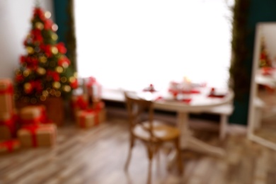 Blurred view of stylish room interior with beautiful Christmas tree