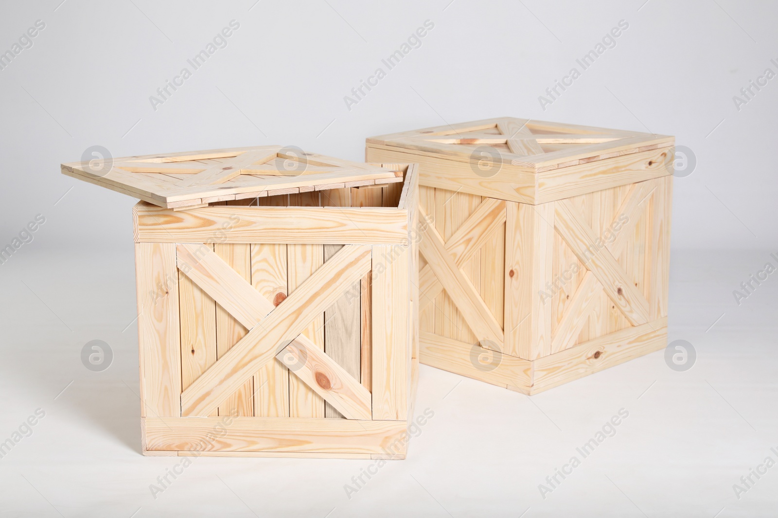 Photo of Pair of wooden crates on grey background