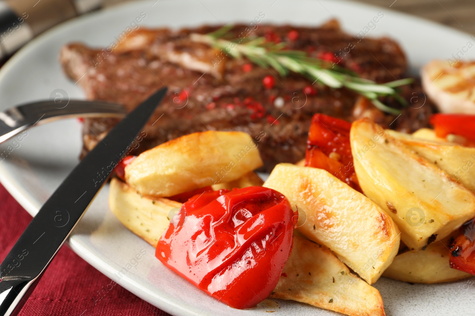 Photo of Delicious grilled beef steak and vegetables on table, closeup