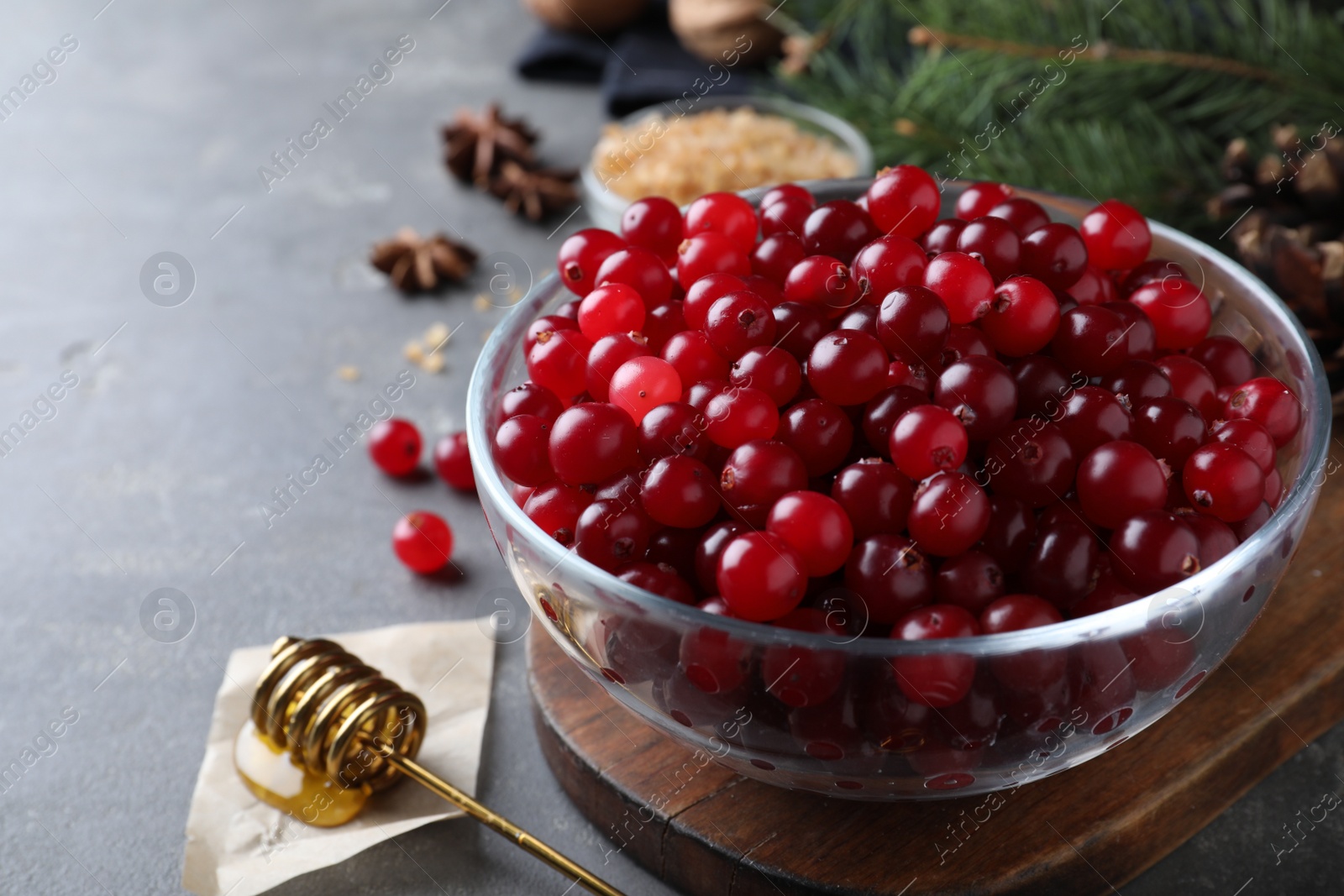 Photo of Fresh ripe cranberries on grey table. Space for text