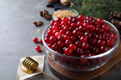 Fresh ripe cranberries on grey table. Space for text