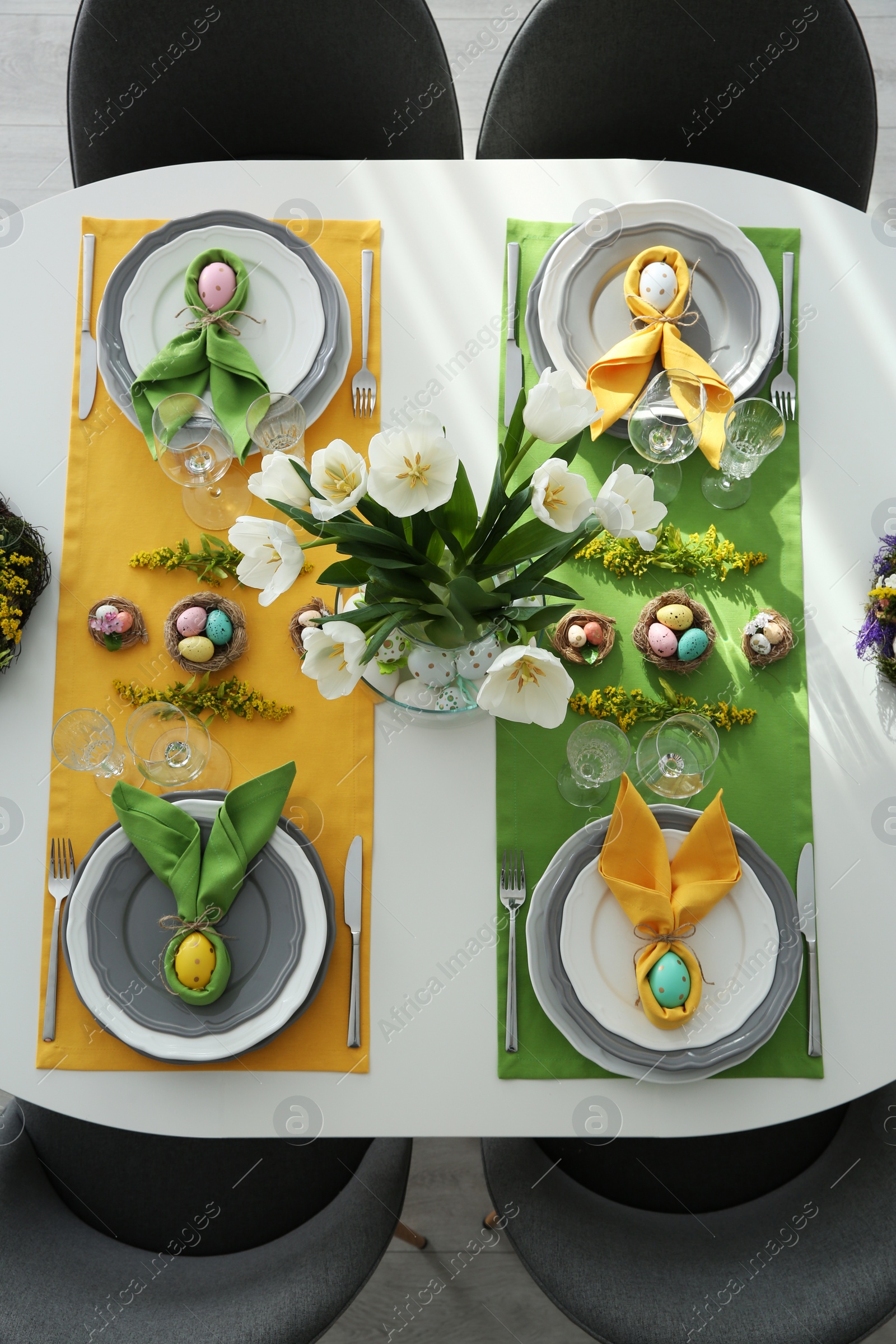 Photo of Festive Easter table setting with beautiful tulips and eggs, top view