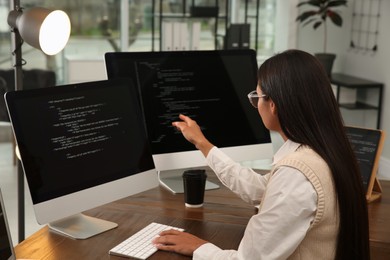 Programmer working at desk in modern office